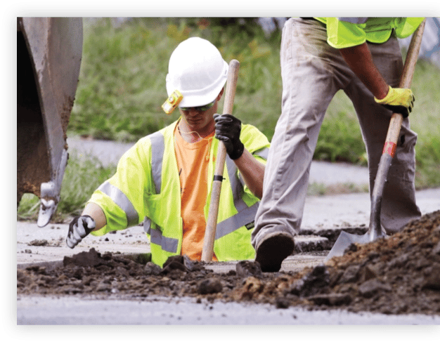 Construction workers digging safely