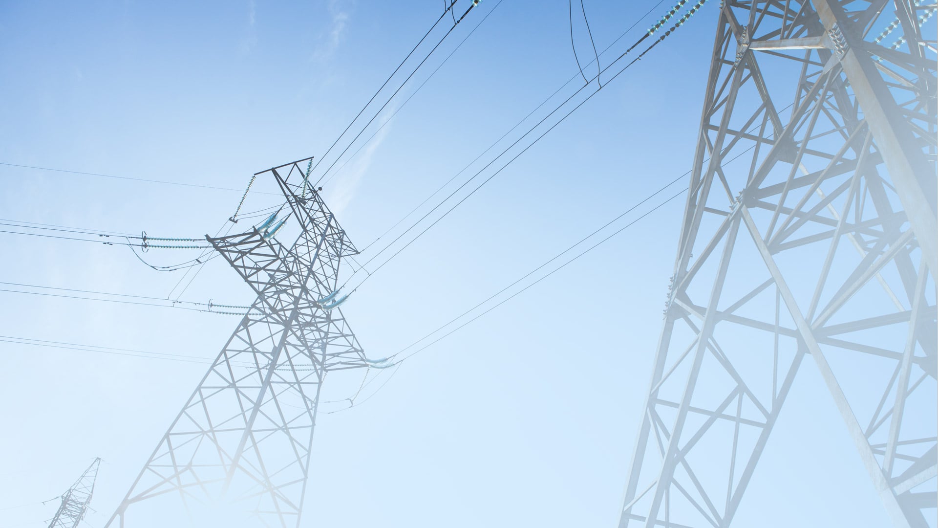 electricity-pylons-against-a-clear-blue-sky-header